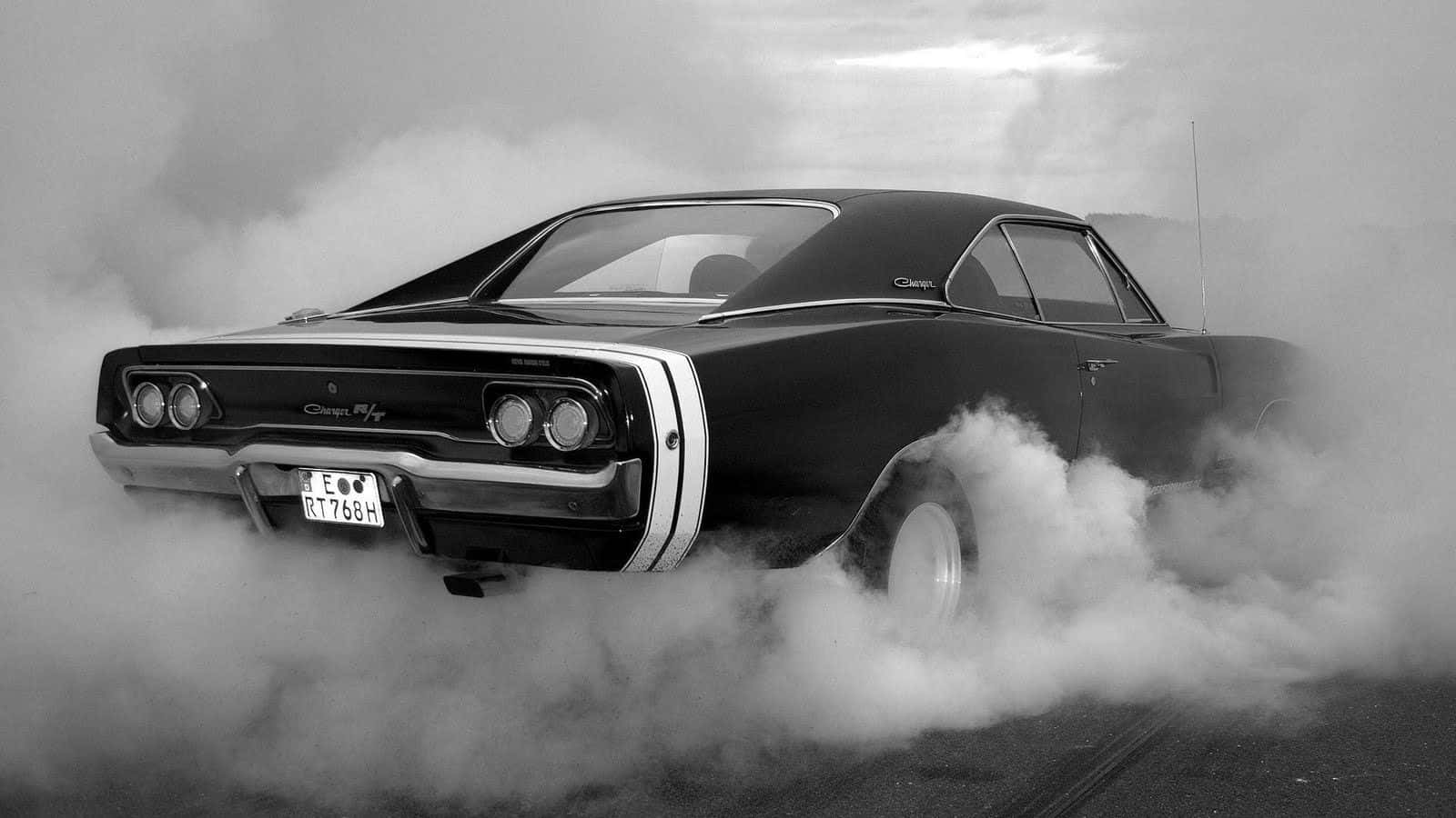 A Black And White Photo Of A Car With Smoke Coming Out Of It