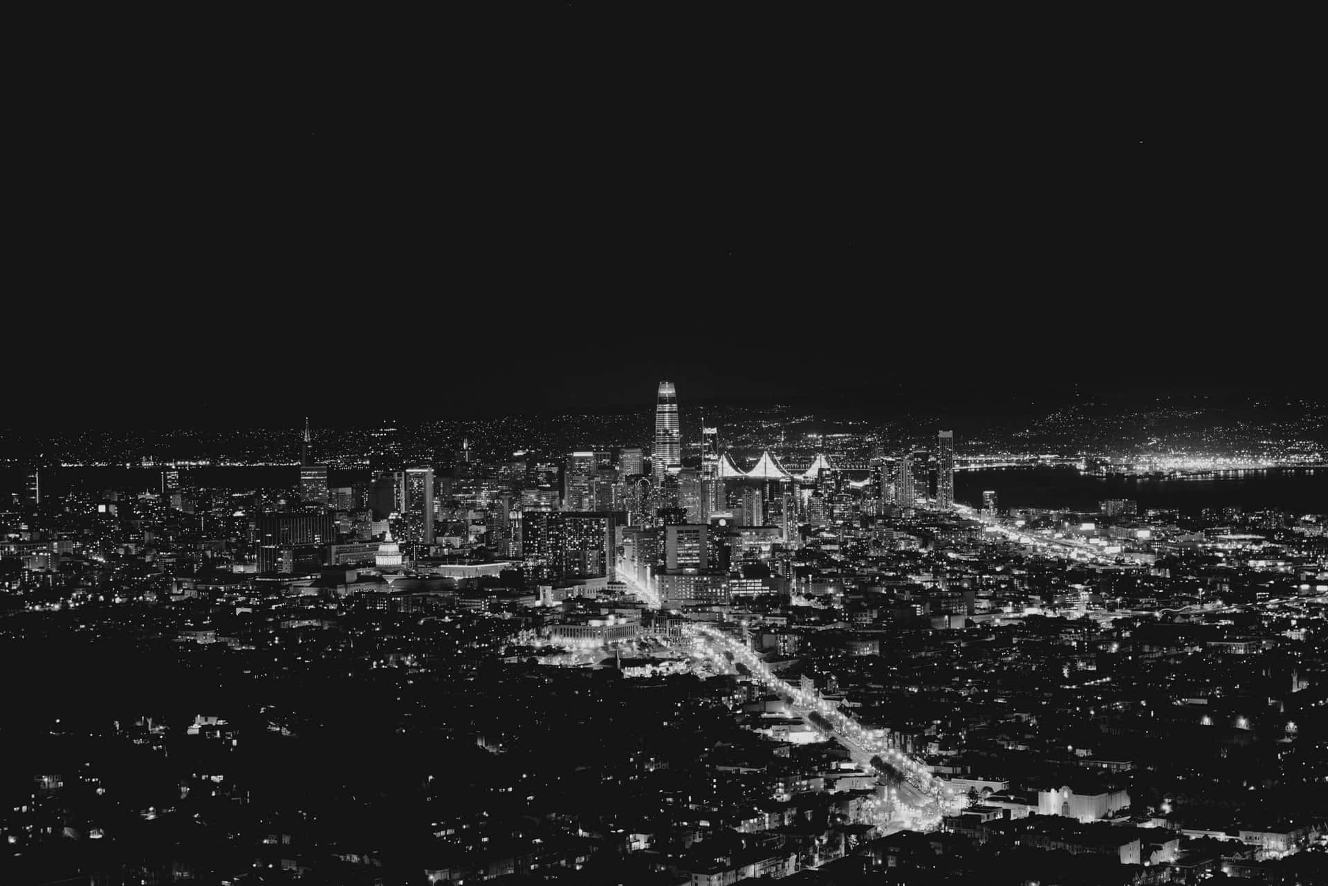 A Black And White Photo Of A City At Night