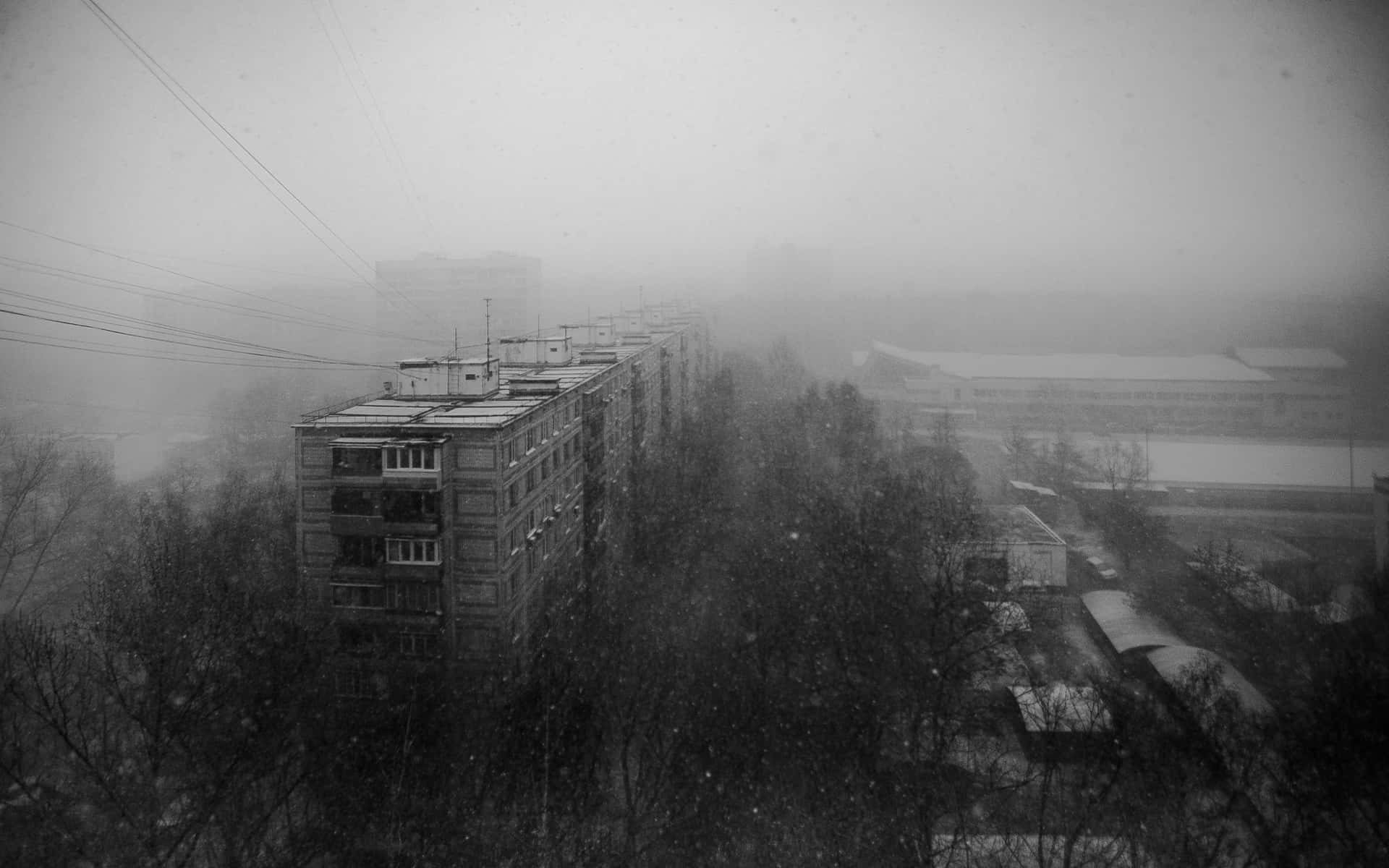 A Black And White Photo Of A City In The Snow Background