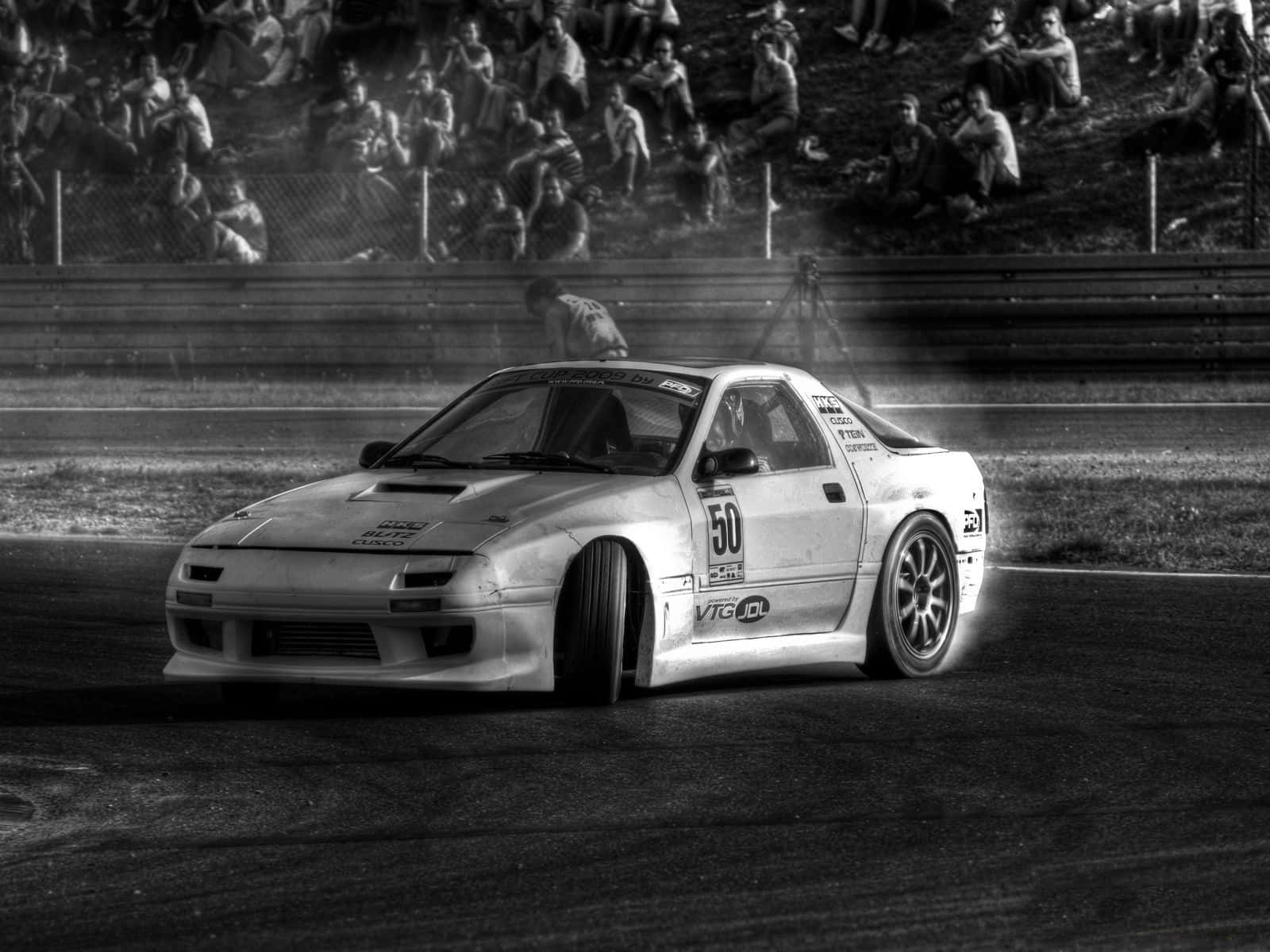 A Black And White Photo Of A Drift Car