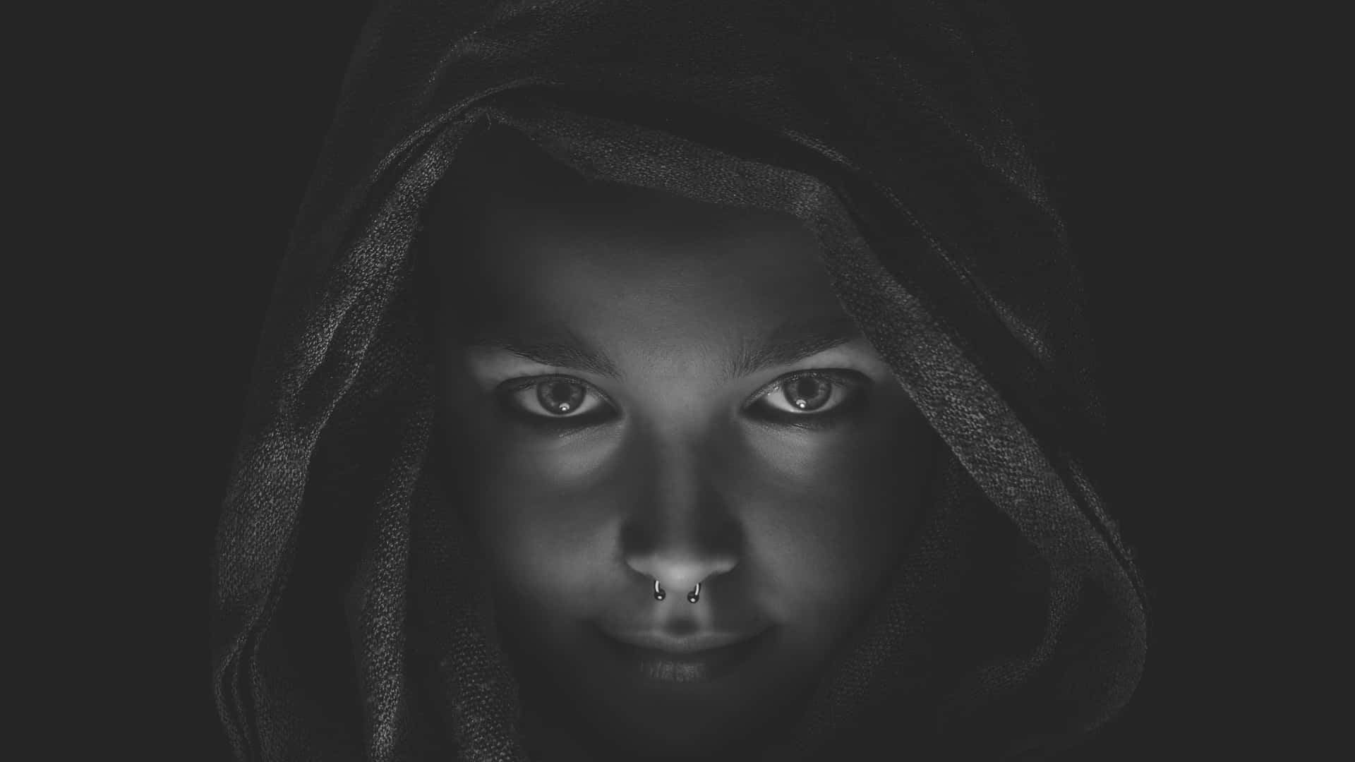 A Black And White Photo Of A Girl With A Hood