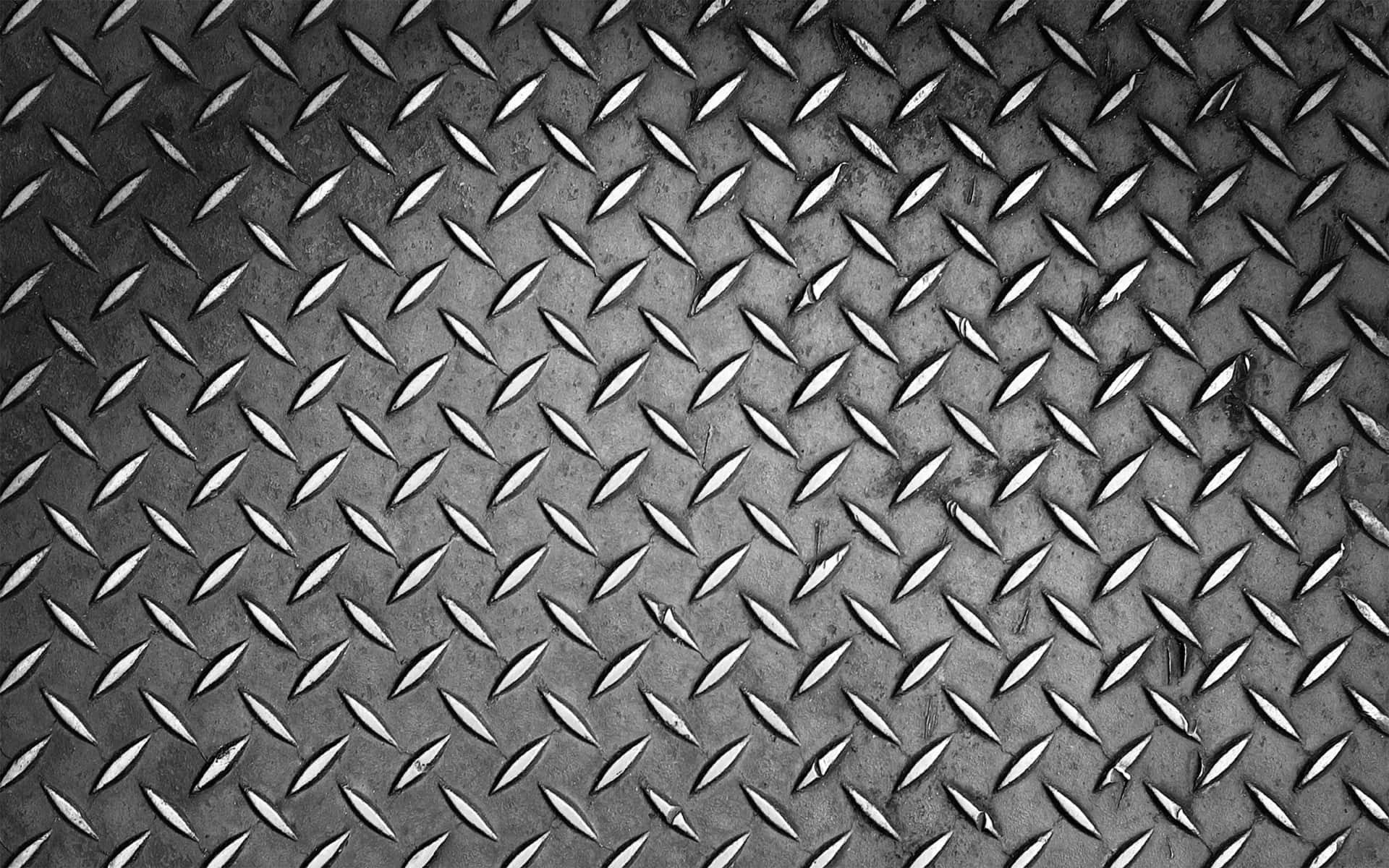 A Black And White Photo Of A Metal Plate Background