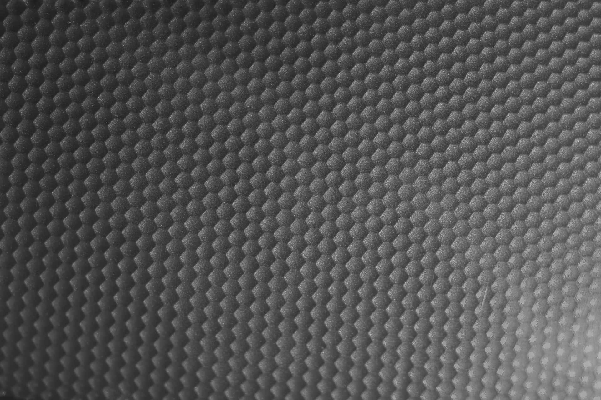 A Black And White Photo Of A Metal Surface