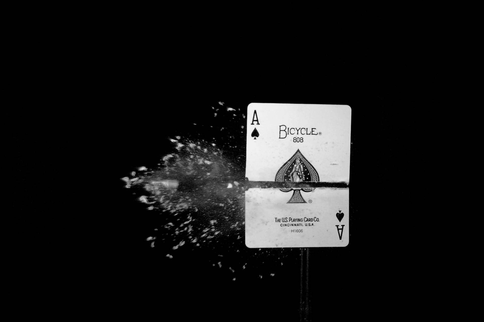 A Black And White Photo Of A Playing Card With A Splash Of Water Background