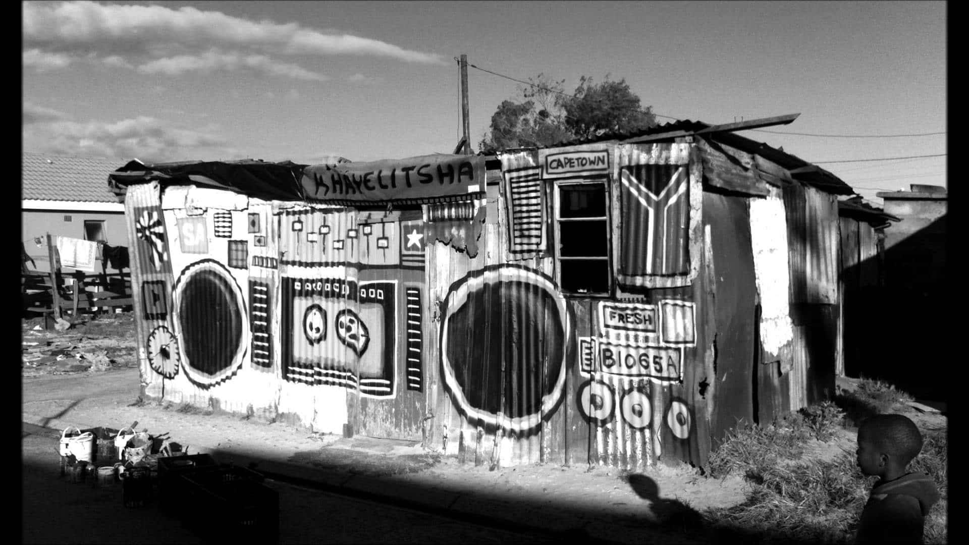 A Black And White Photo Of A Shack With Speakers Background