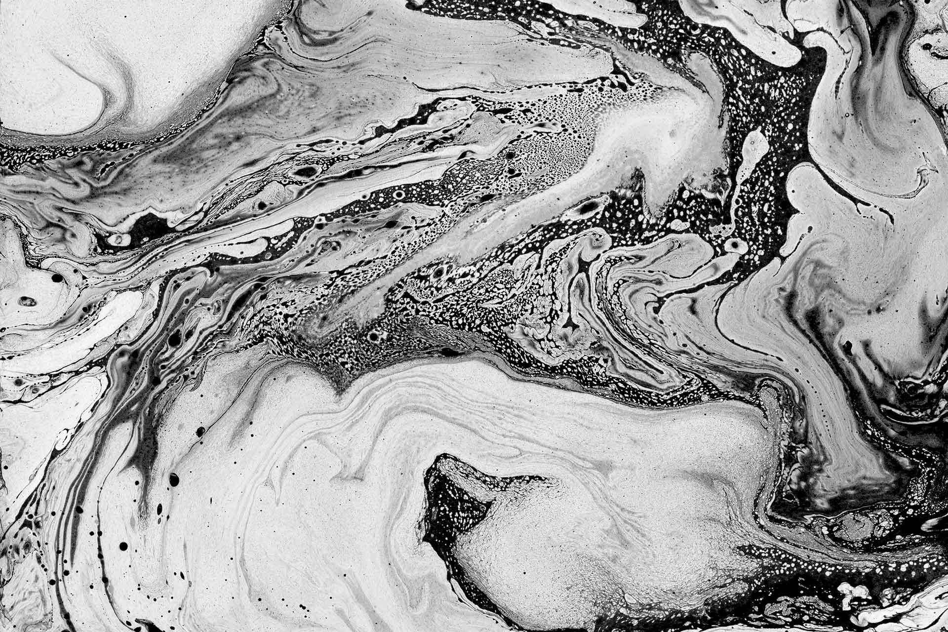 A Black And White Photo Of A Swirling Liquid Background