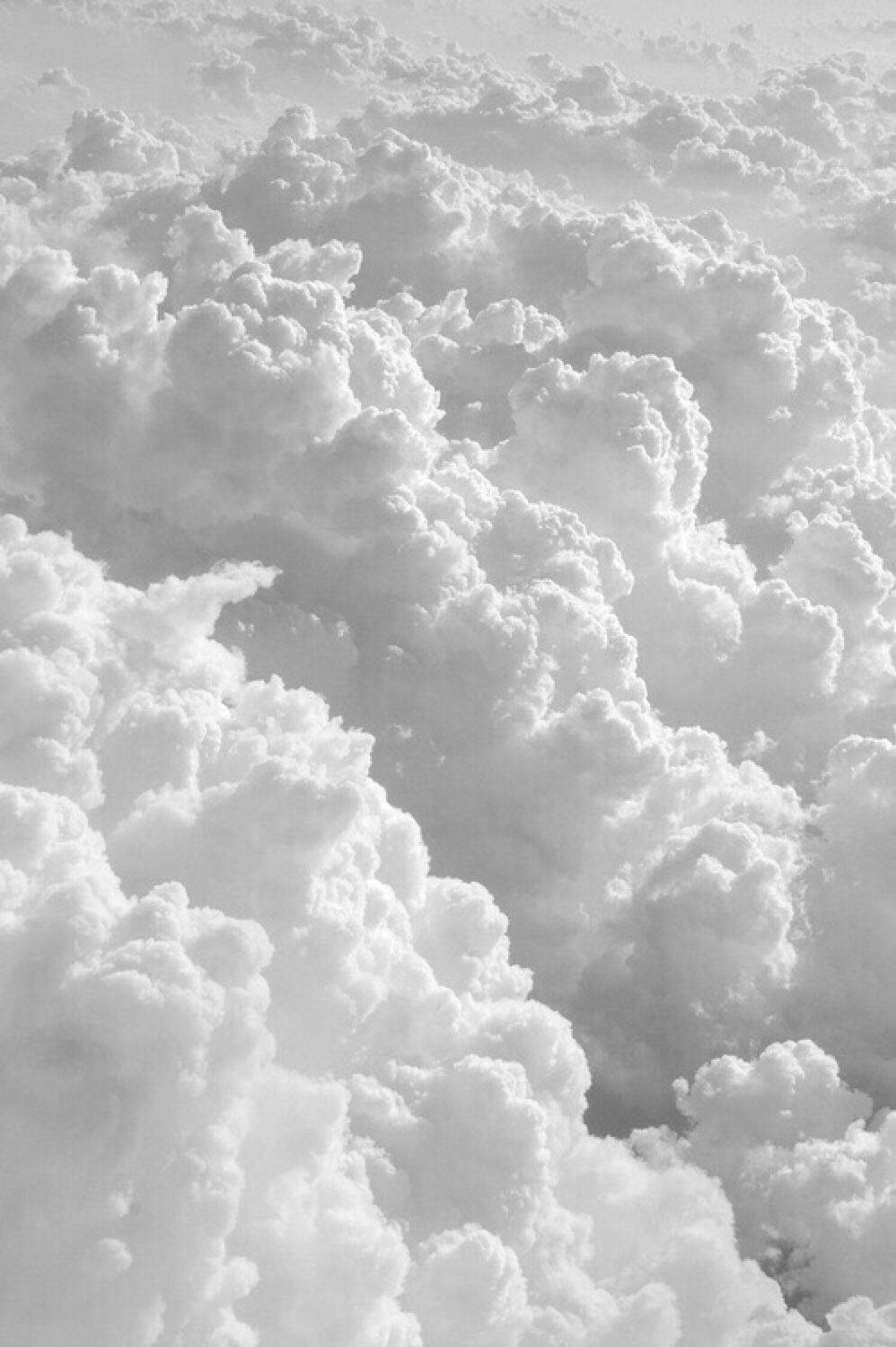 A Black And White Photo Of Clouds Above The Ground Background