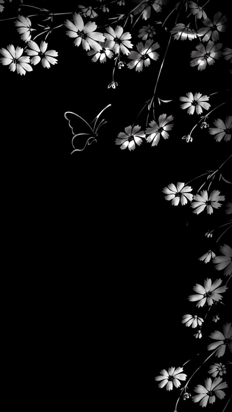 A Black And White Photo Of Flowers And A Butterfly