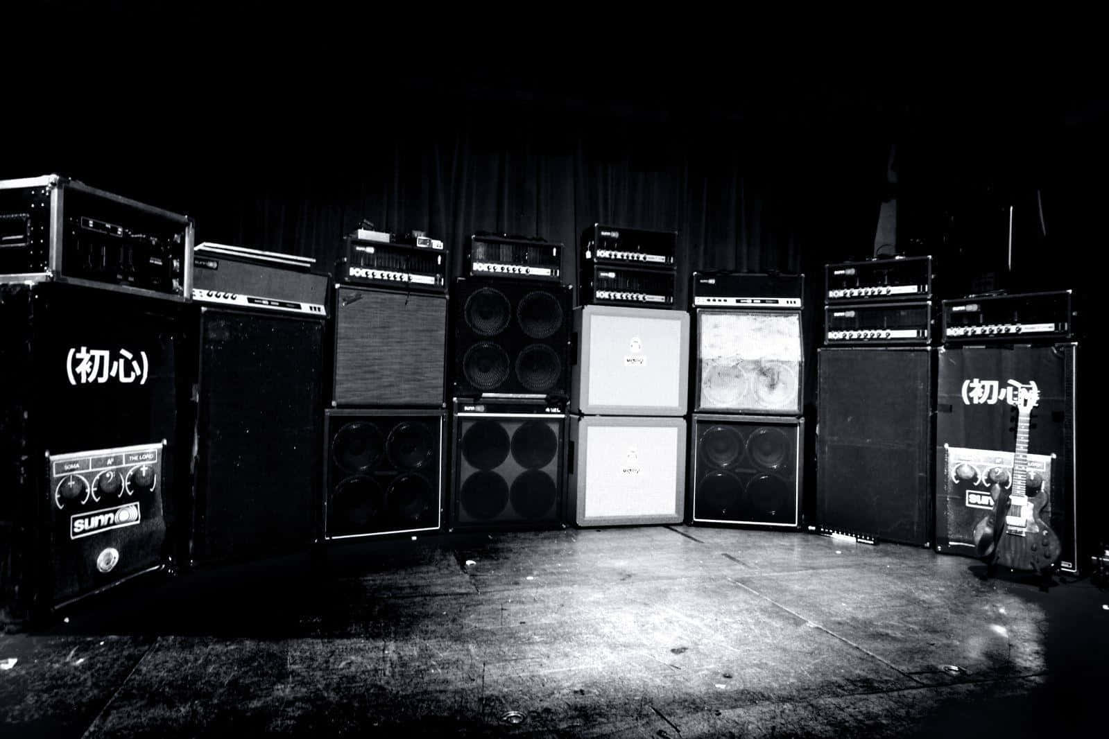A Black And White Photo Of Several Amps In A Room Background