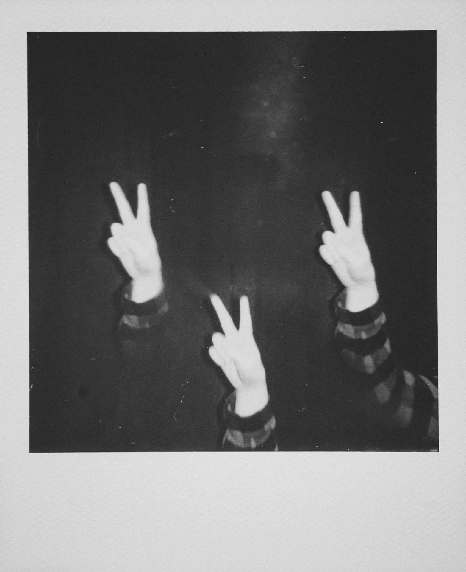 A Black And White Photo Of Three People Making Peace Signs Background