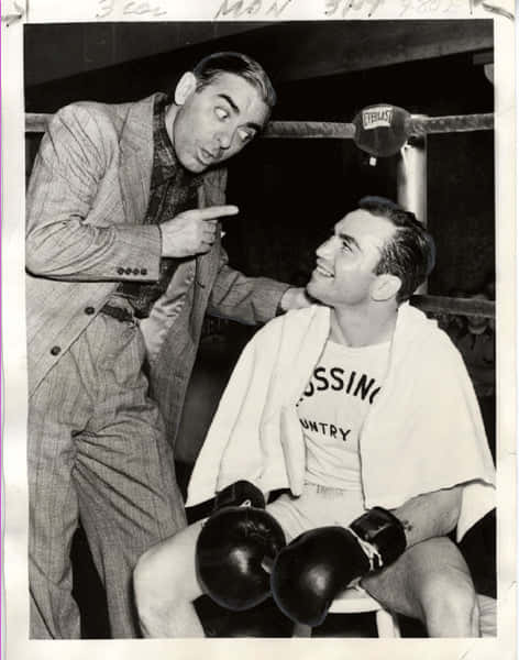 A Black And White Photo Of Two Men In Boxing Gloves Background