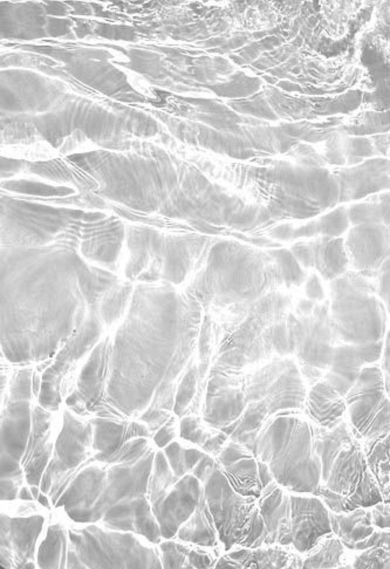 A Black And White Photo Of Water In The Ocean