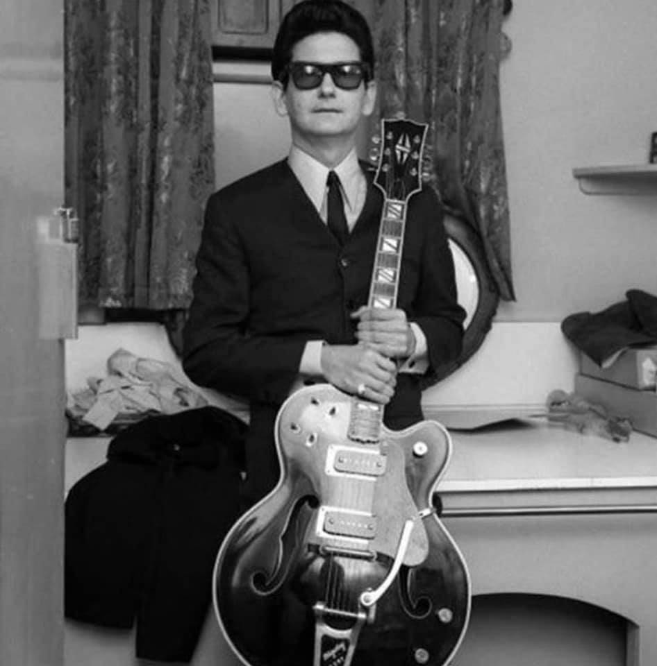 A Black And White Portrait Of Roy Orbison: The Iconic American Singer-songwriter Background