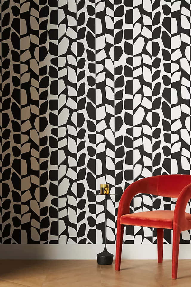 A Black And White Wallpaper With A Red Chair Background