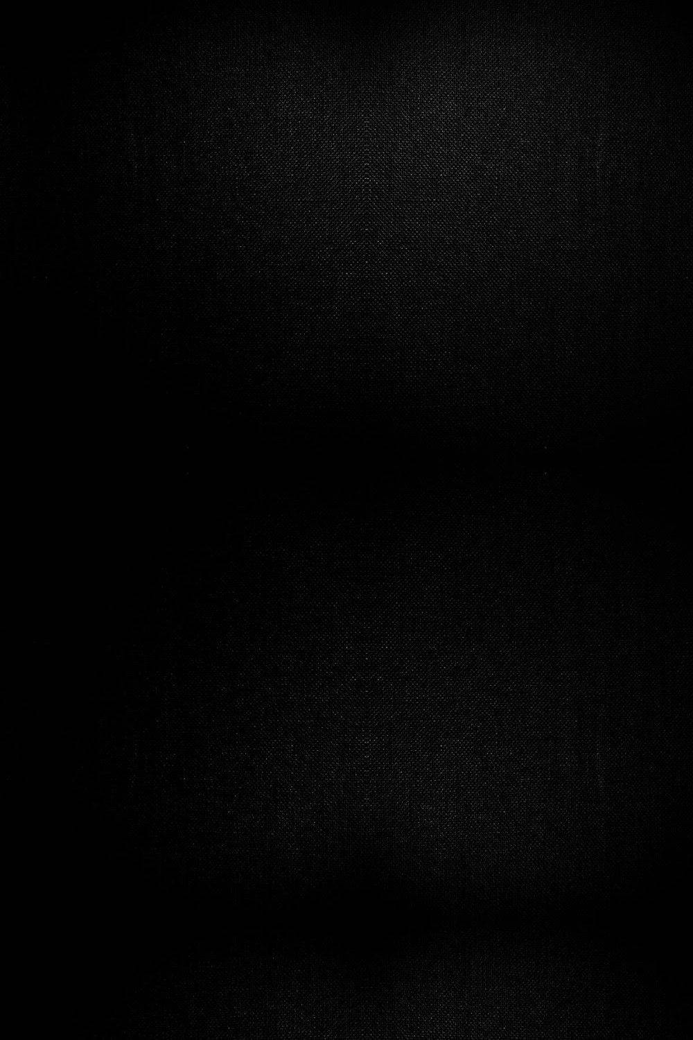 A Black Background With A Light Shining On It Background