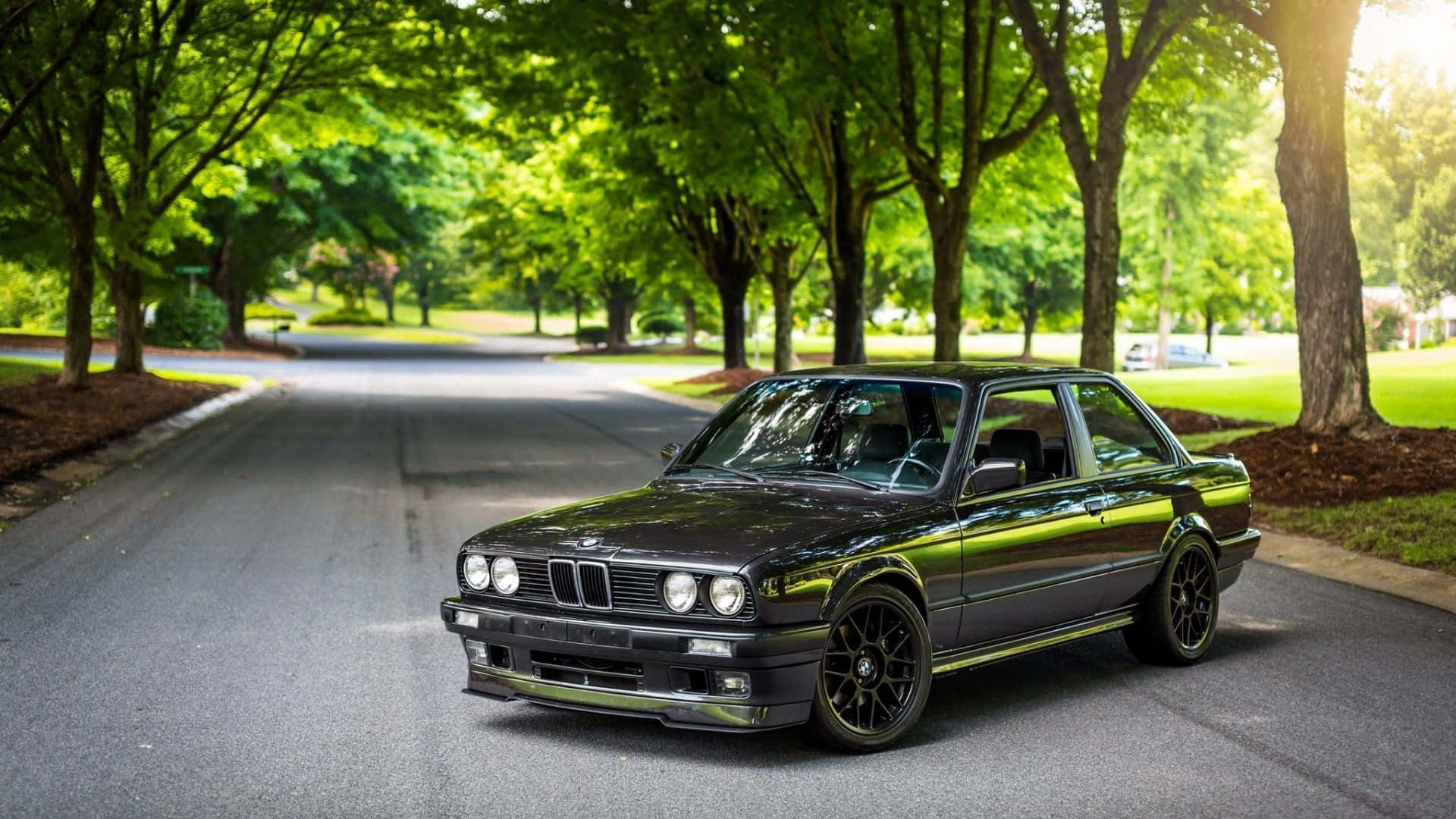 A Black Bmw E30 Parked On The Side Of The Road Background