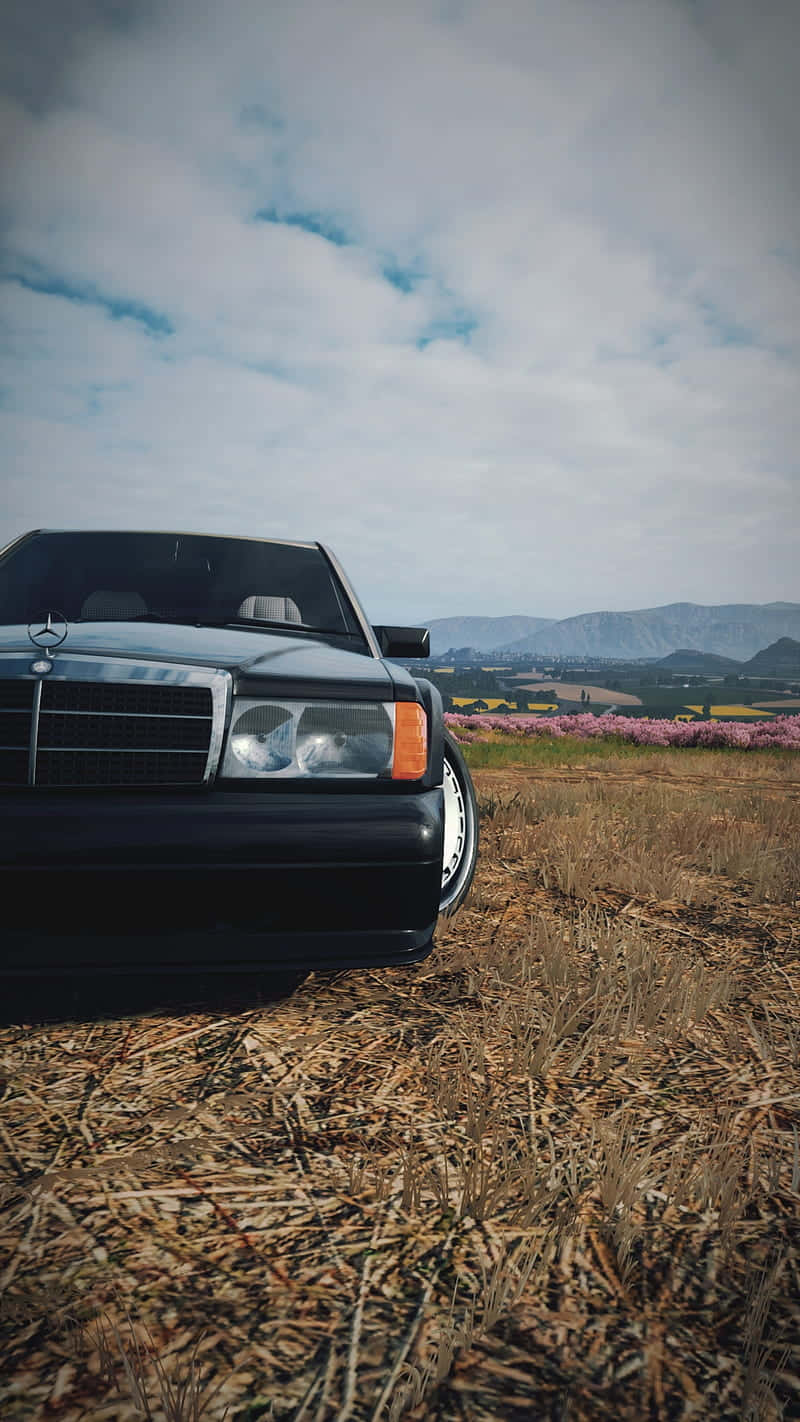 A Black Car In A Field Background