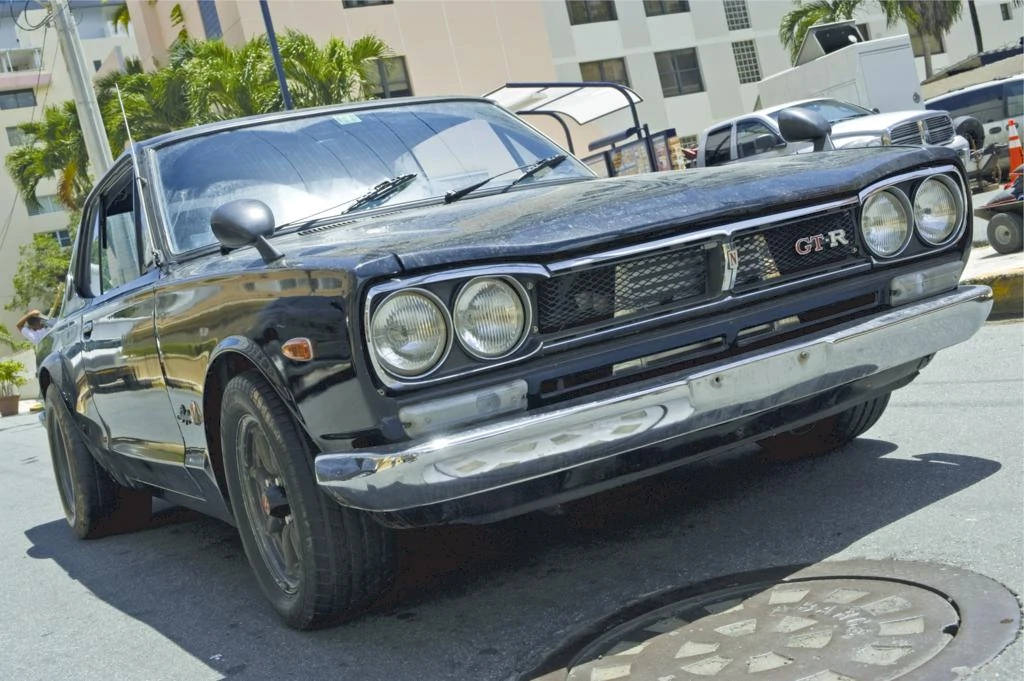 A Black Car Parked On A Street Background