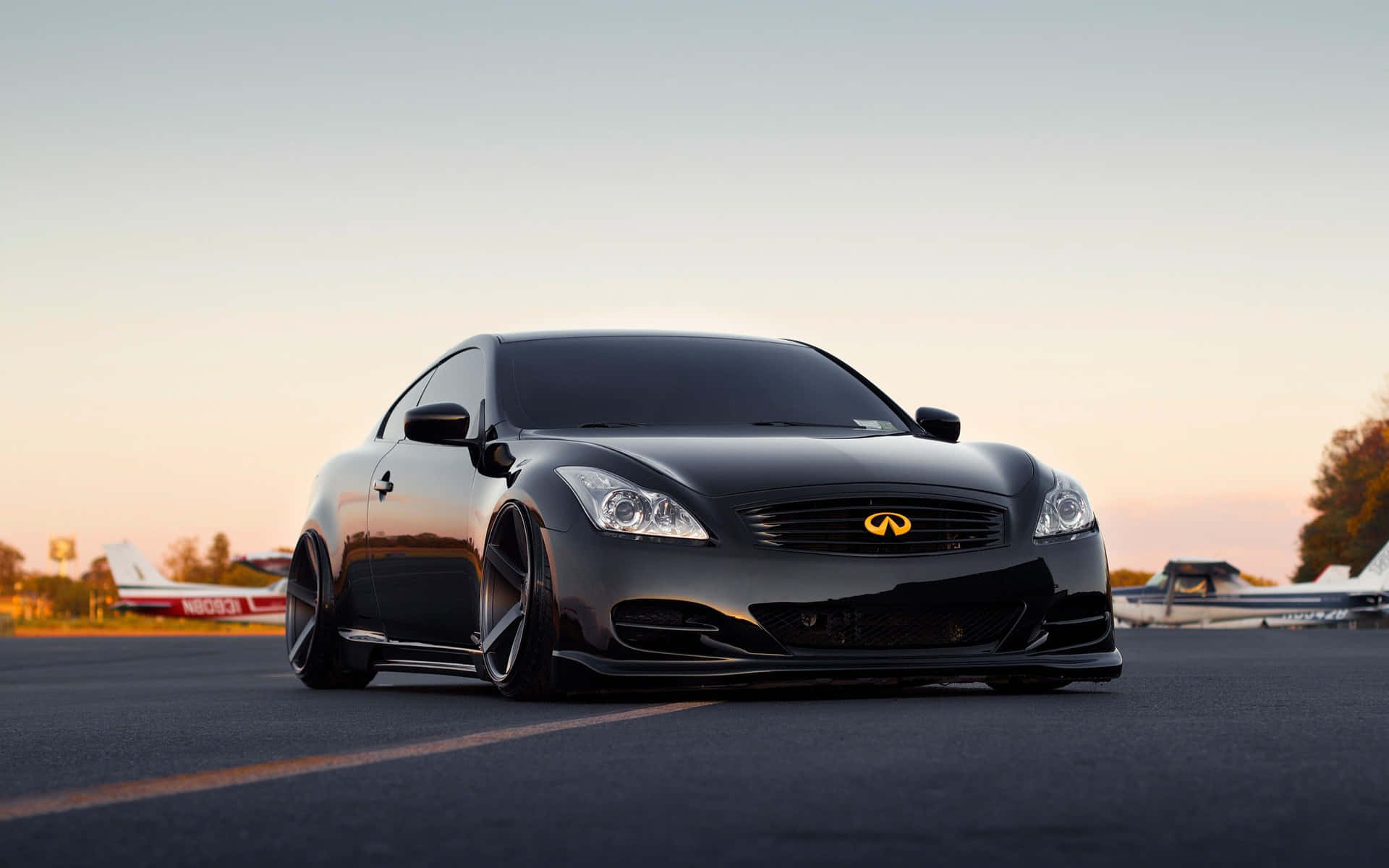 A Black Car Parked On The Runway Background