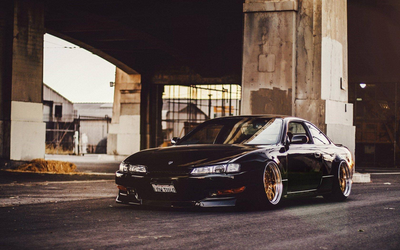 A Black Car Parked Under An Overpass