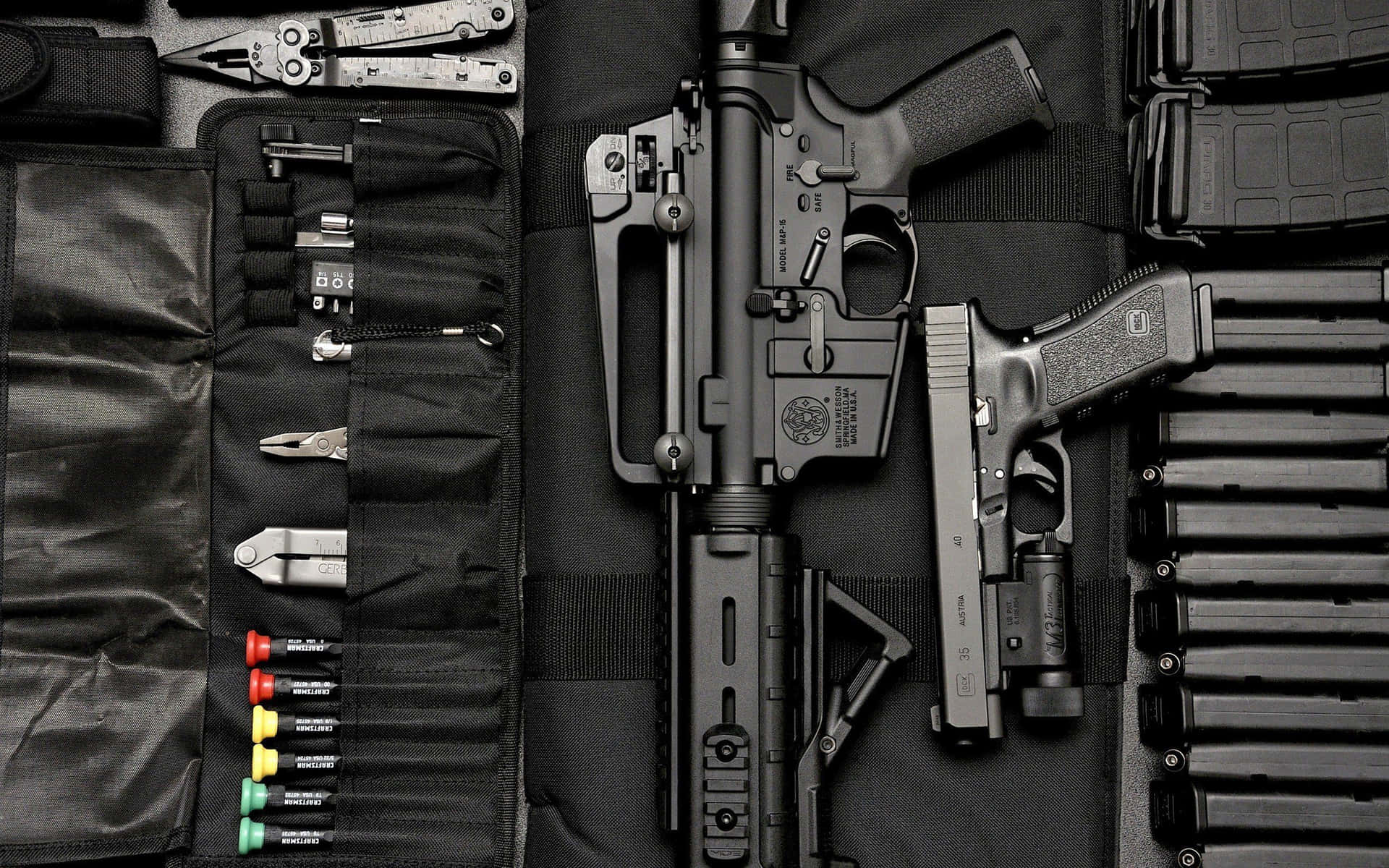 A Black Case With Several Guns And Accessories Background