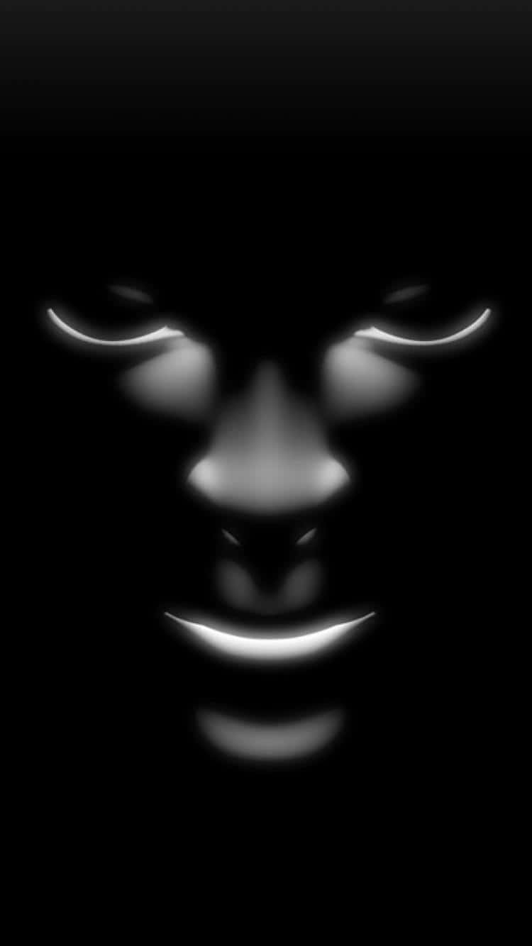 A Black Face With Glowing Eyes Background