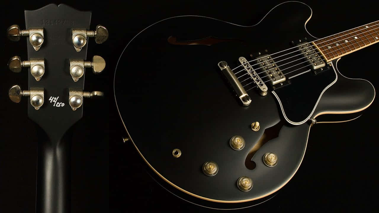 A Black Guitar With A Black Headstock Background