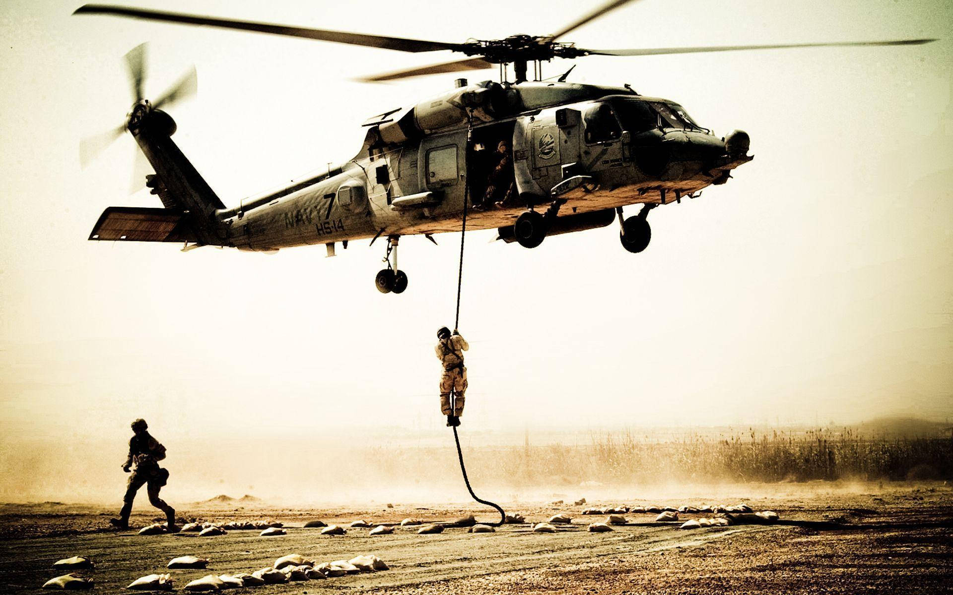 A Black Hawk Helicopter Soars Through The Sky Background