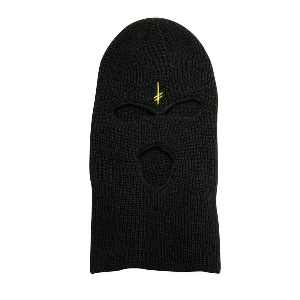 A Black Knit Mask With A Gold Logo Background