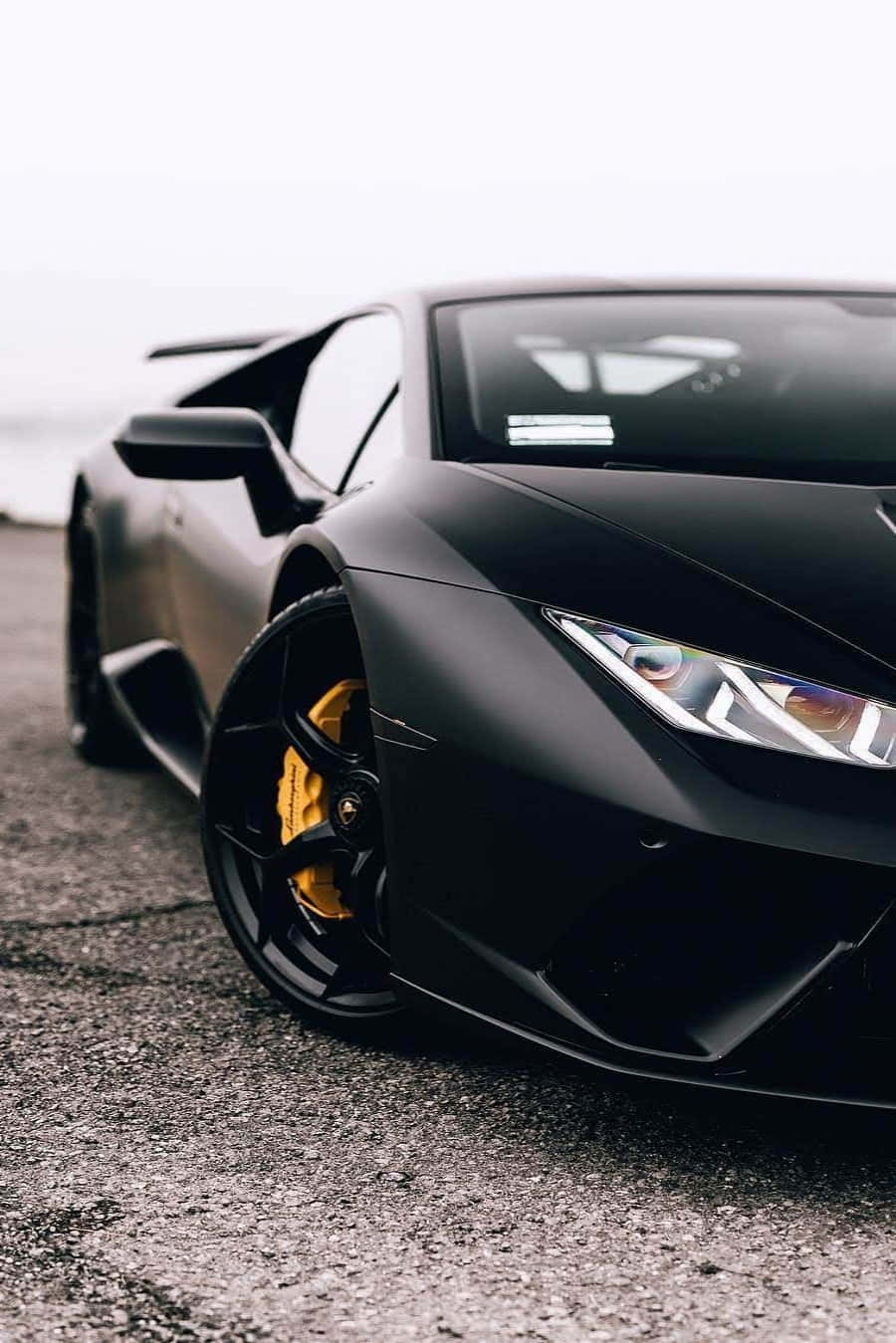 A Black Lamborghini Parked On The Side Of The Road Background