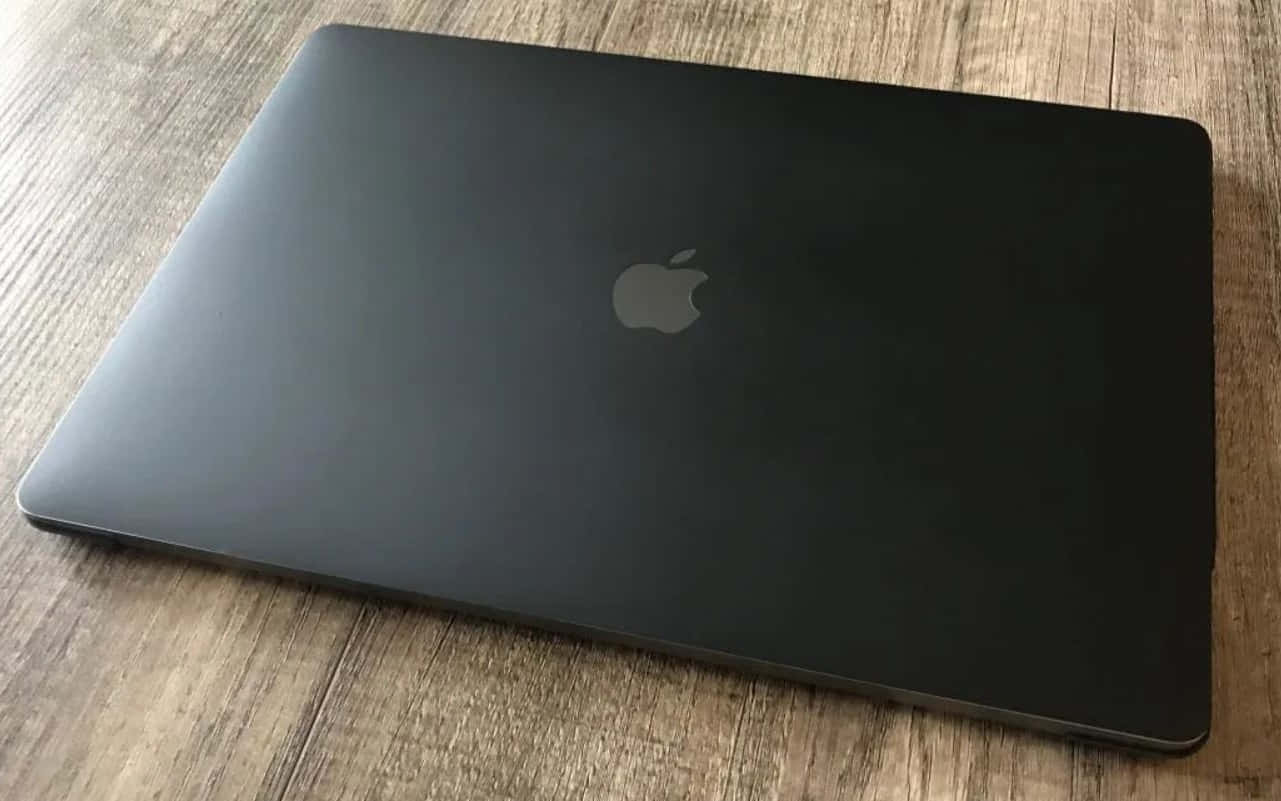 A Black Macbook With A Clean Design Background