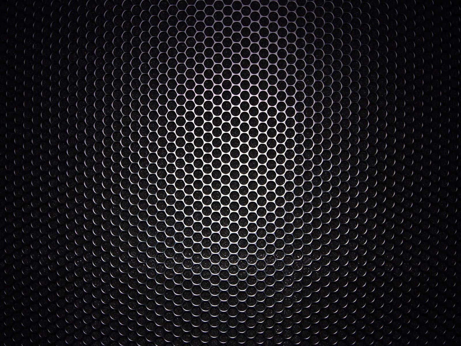 A Black Metal Grille With Holes In It Background