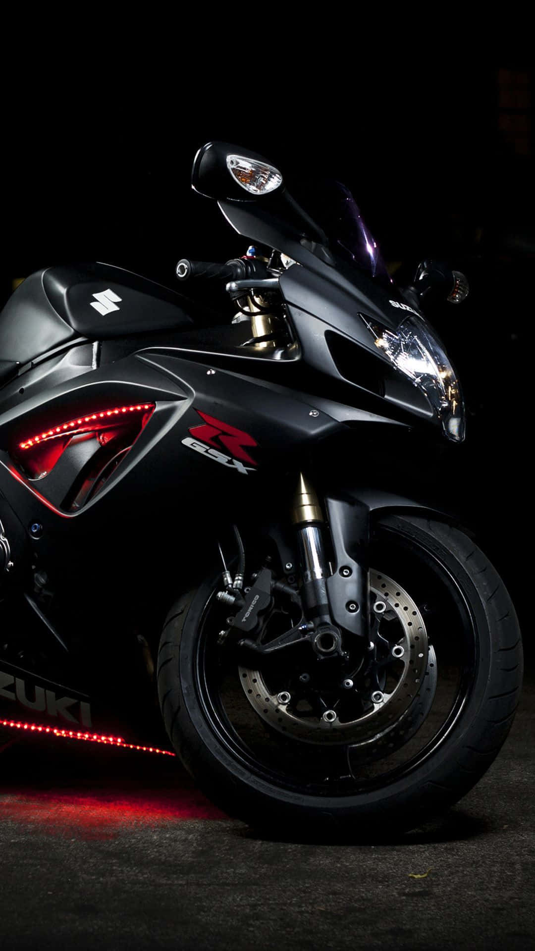 A Black Motorcycle Is Parked In A Dark Area