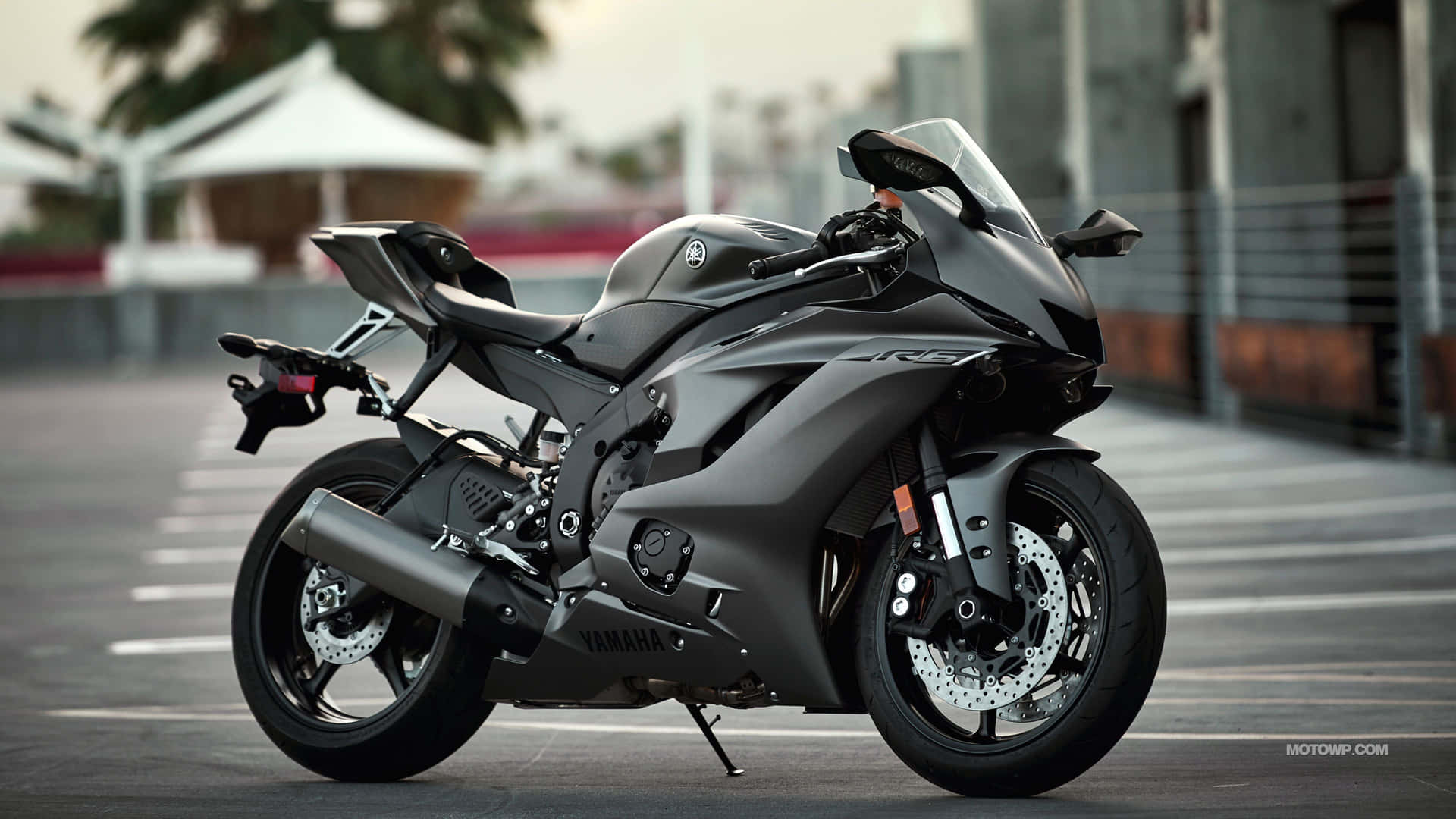 A Black Motorcycle Is Parked On A Street Background