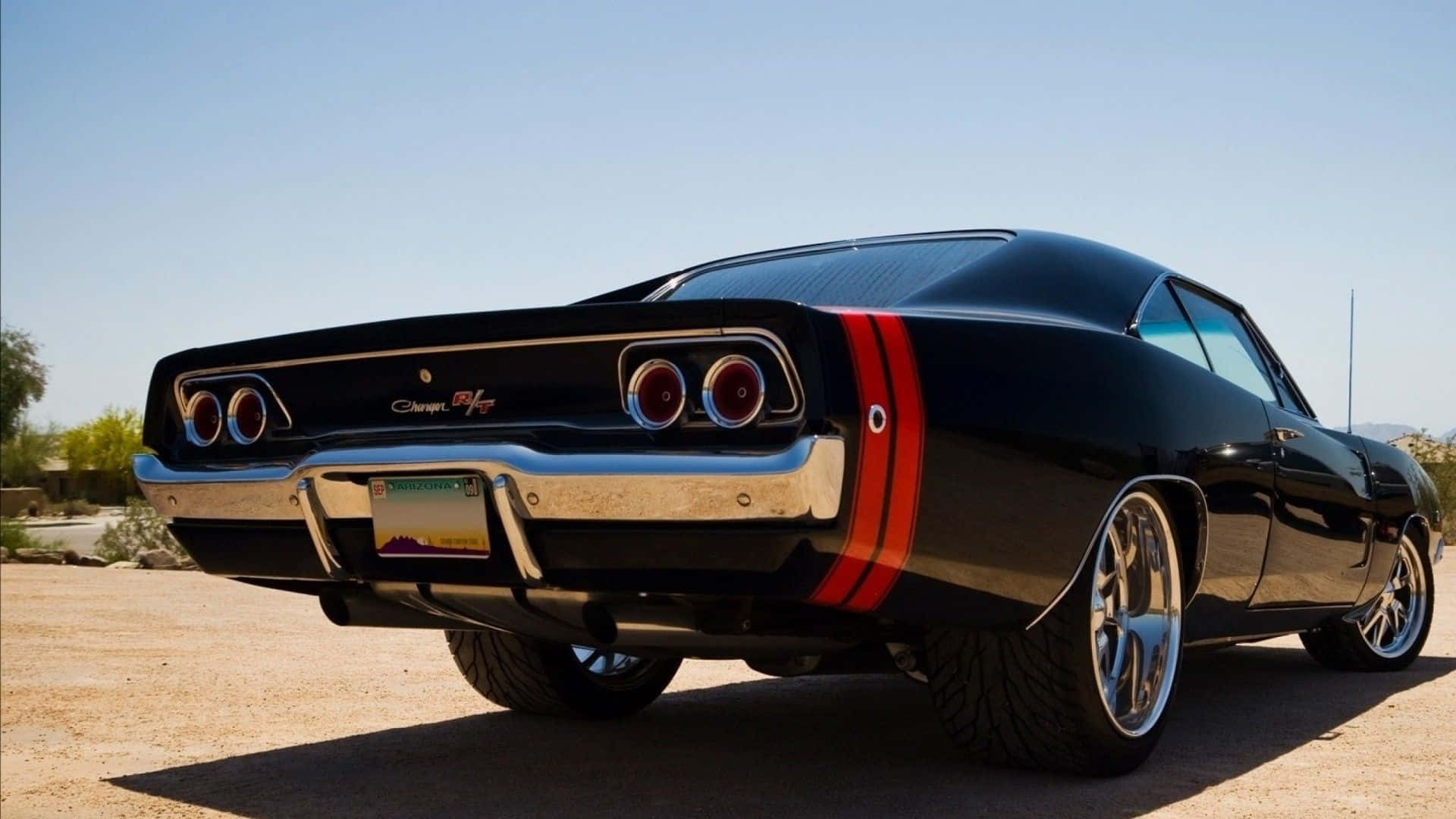 A Black Muscle Car Parked In The Desert Background