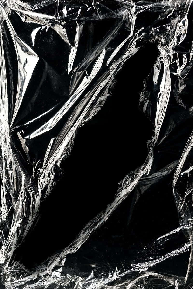 A Black Plastic Cover With A Black Background Background