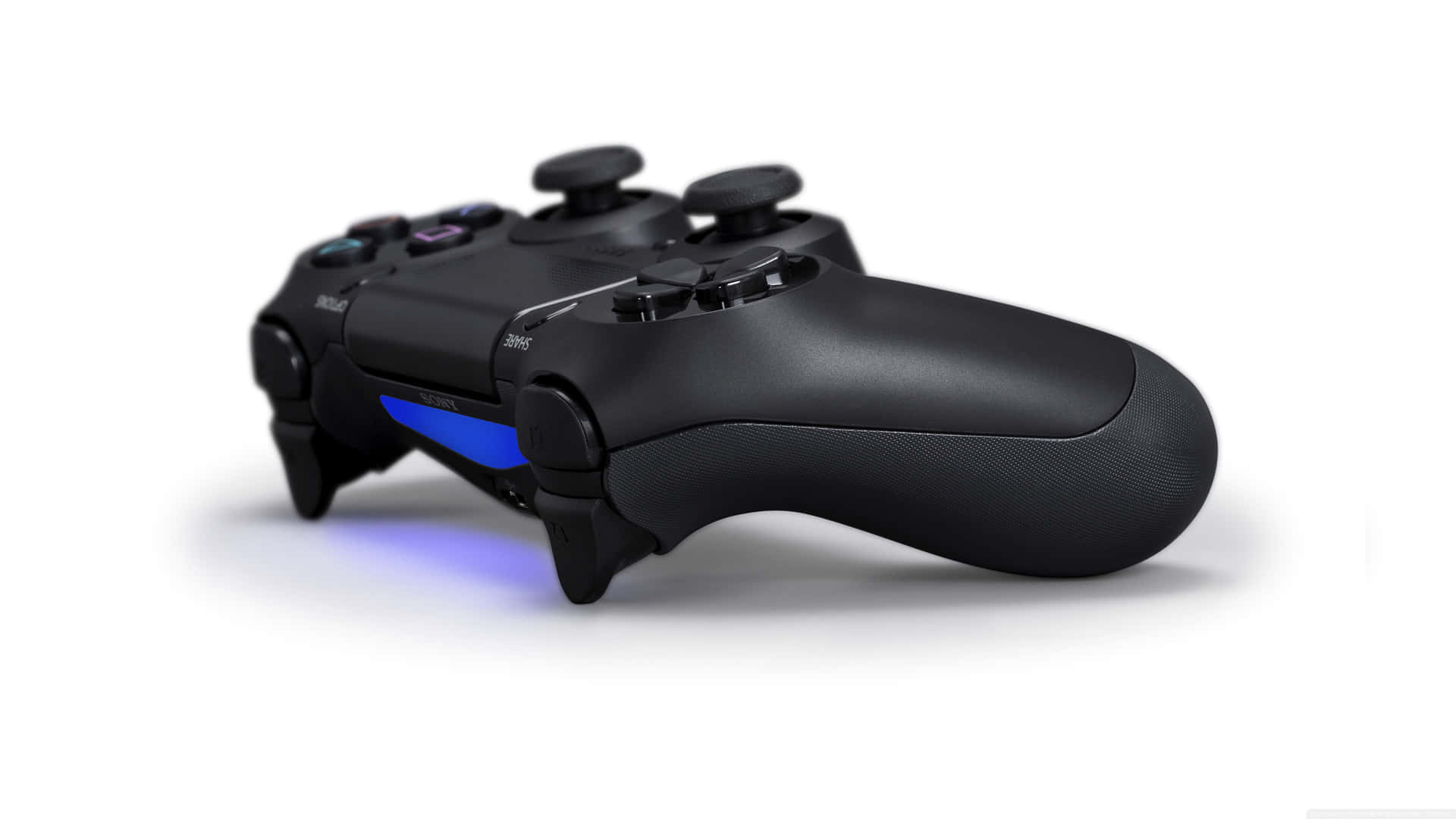 A Black Playstation Controller With Blue Lights Background