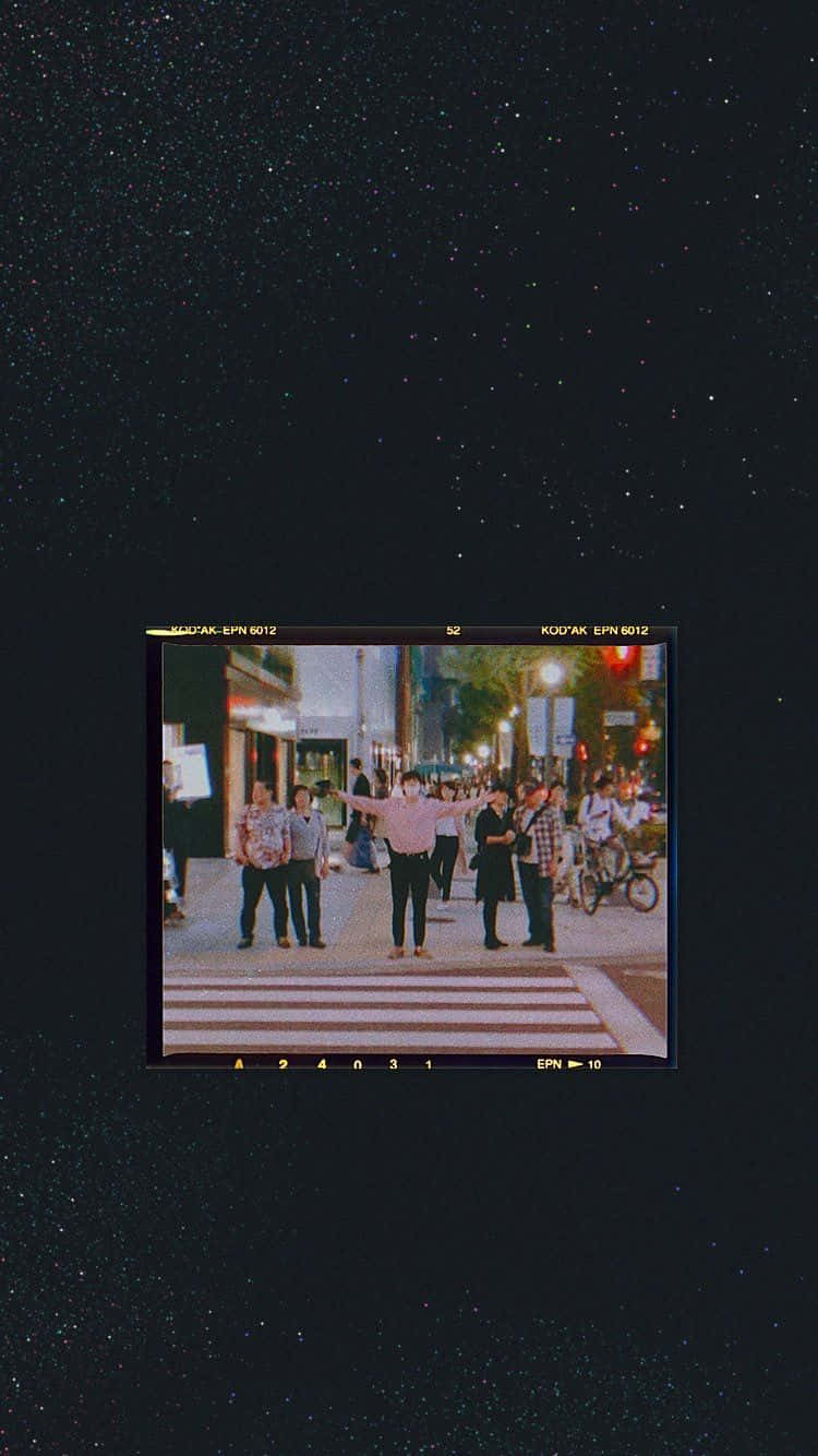 A Black Screen With A Picture Of People On A Street