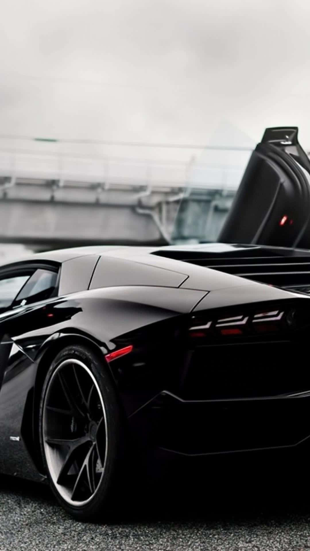 A Black Sports Car With Its Doors Open