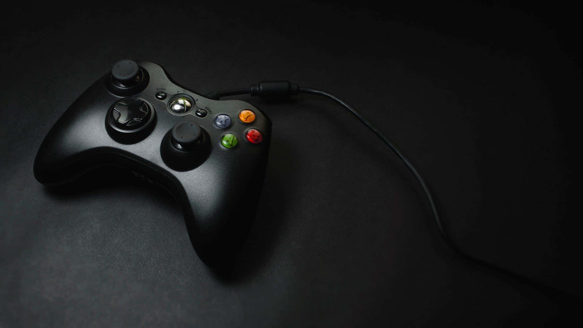 A Black Xbox Controller On A Black Surface Background