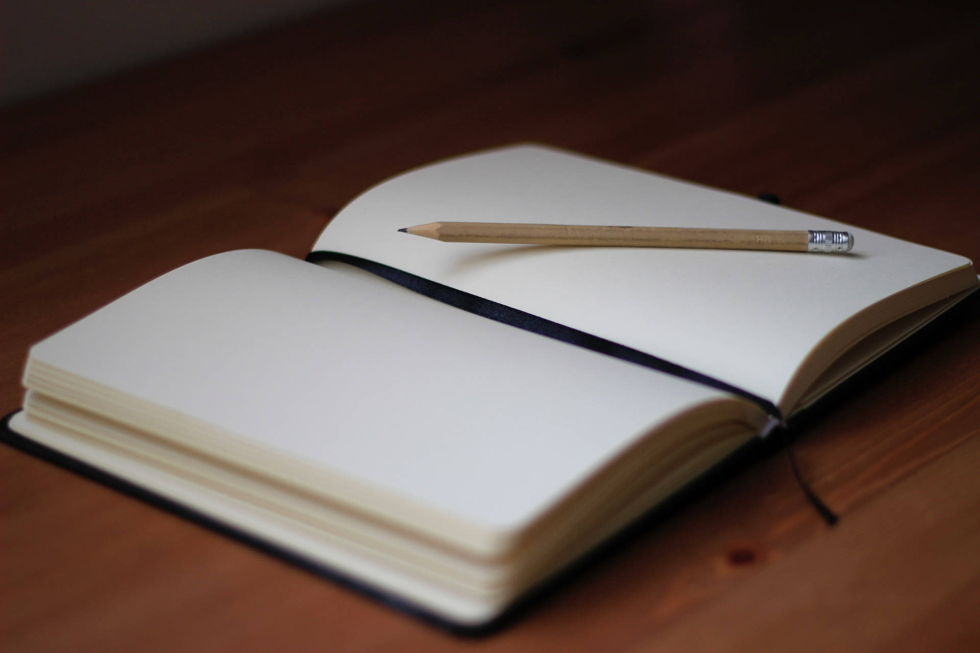 A Blank Page From A Thick Notebook With A Pencil On Top Background