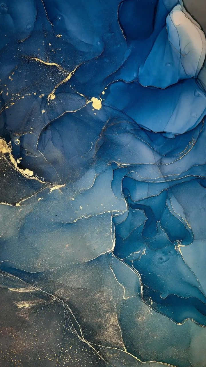 A Blue And Gold Liquid Is Floating In The Air Background