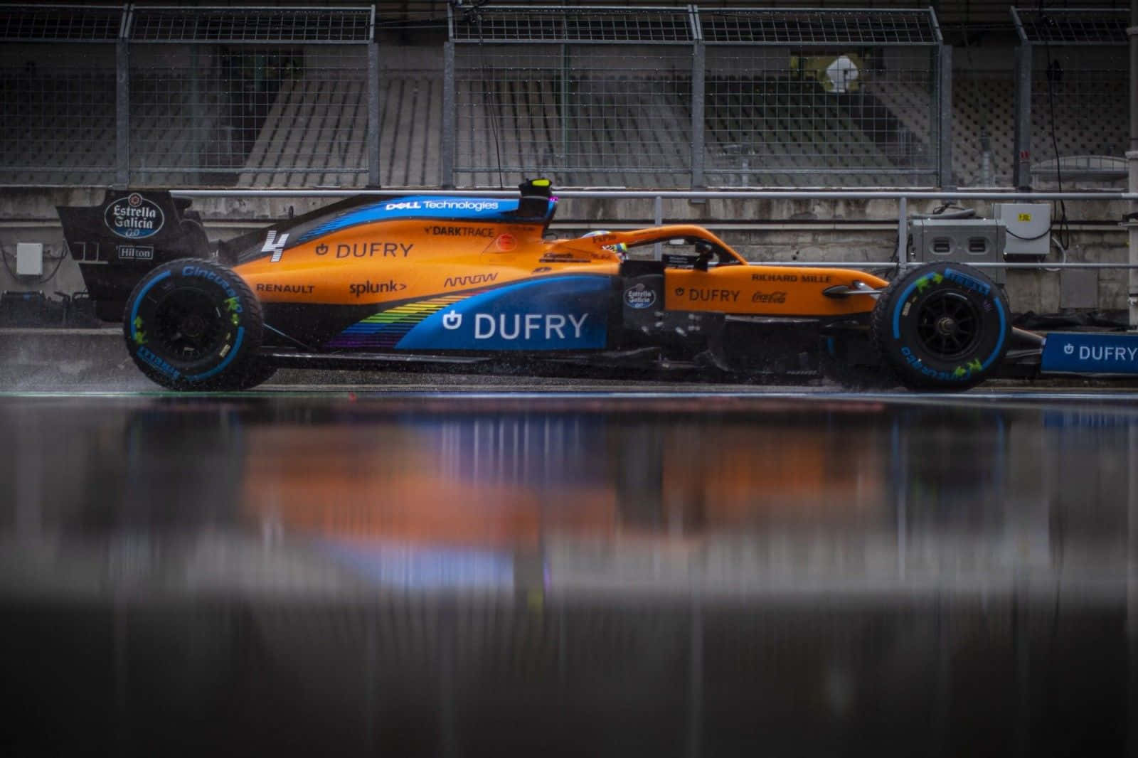 A Blue And Orange Racing Car Is Sitting On The Track Background