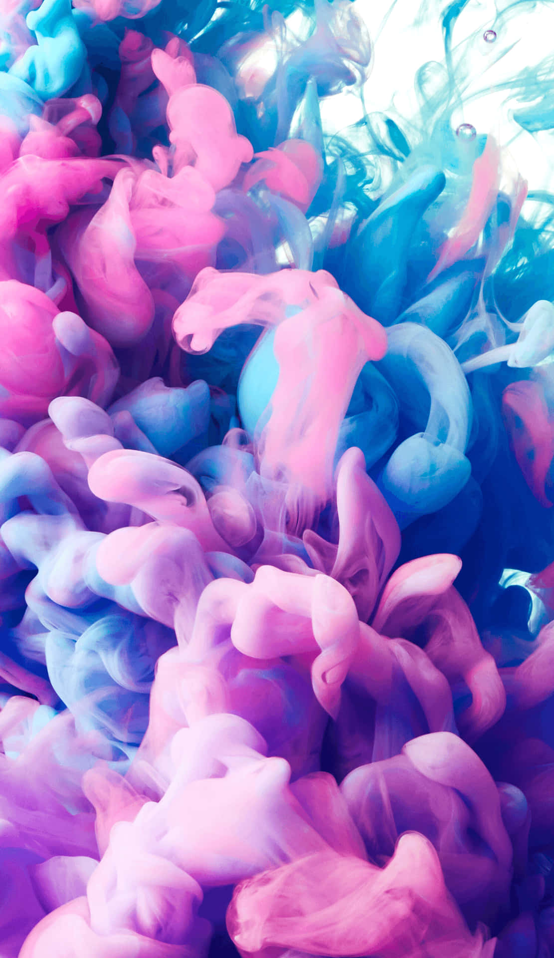 A Blue And Pink Liquid Is Floating In The Air Background