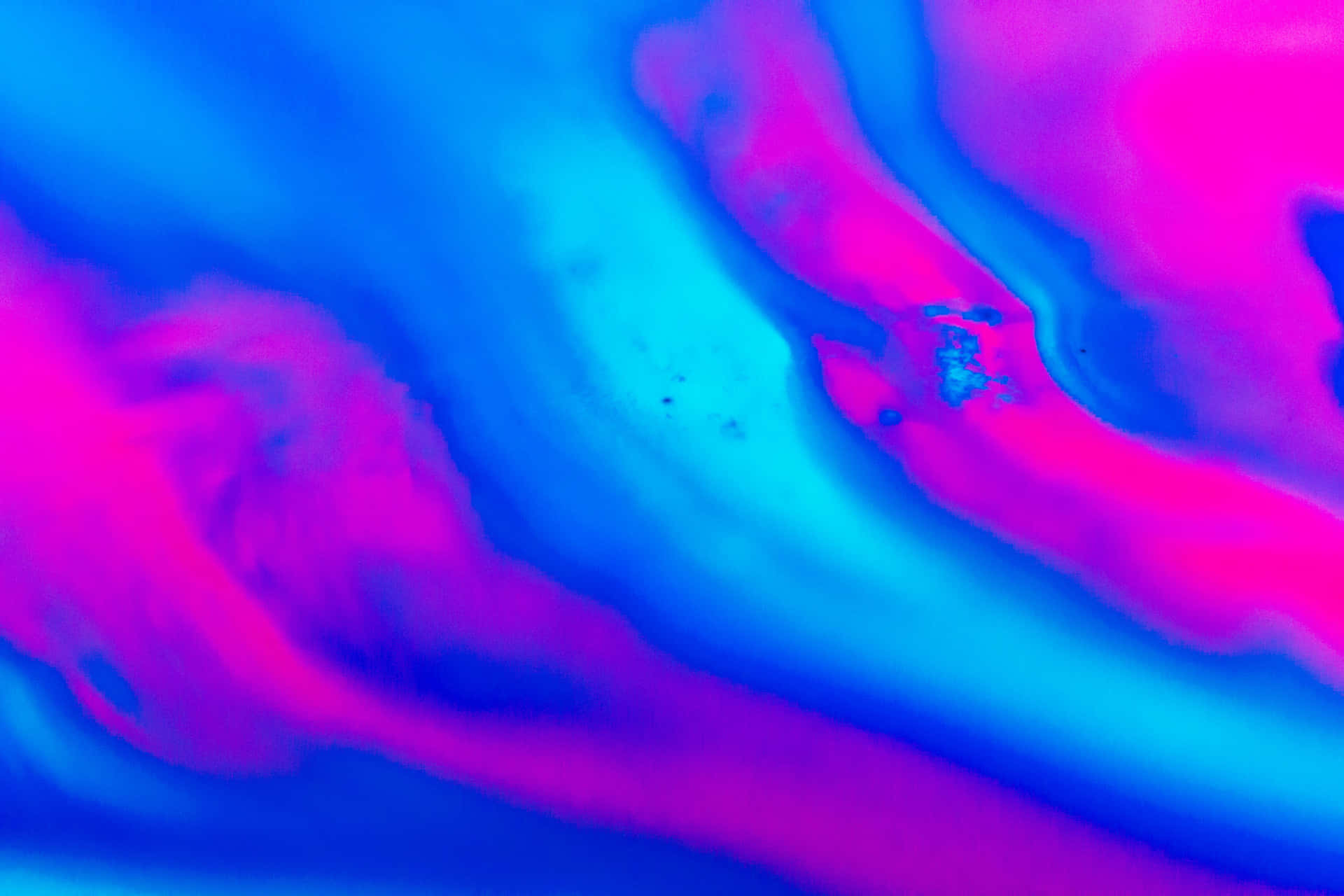 A Blue And Pink Liquid Is Floating In The Air