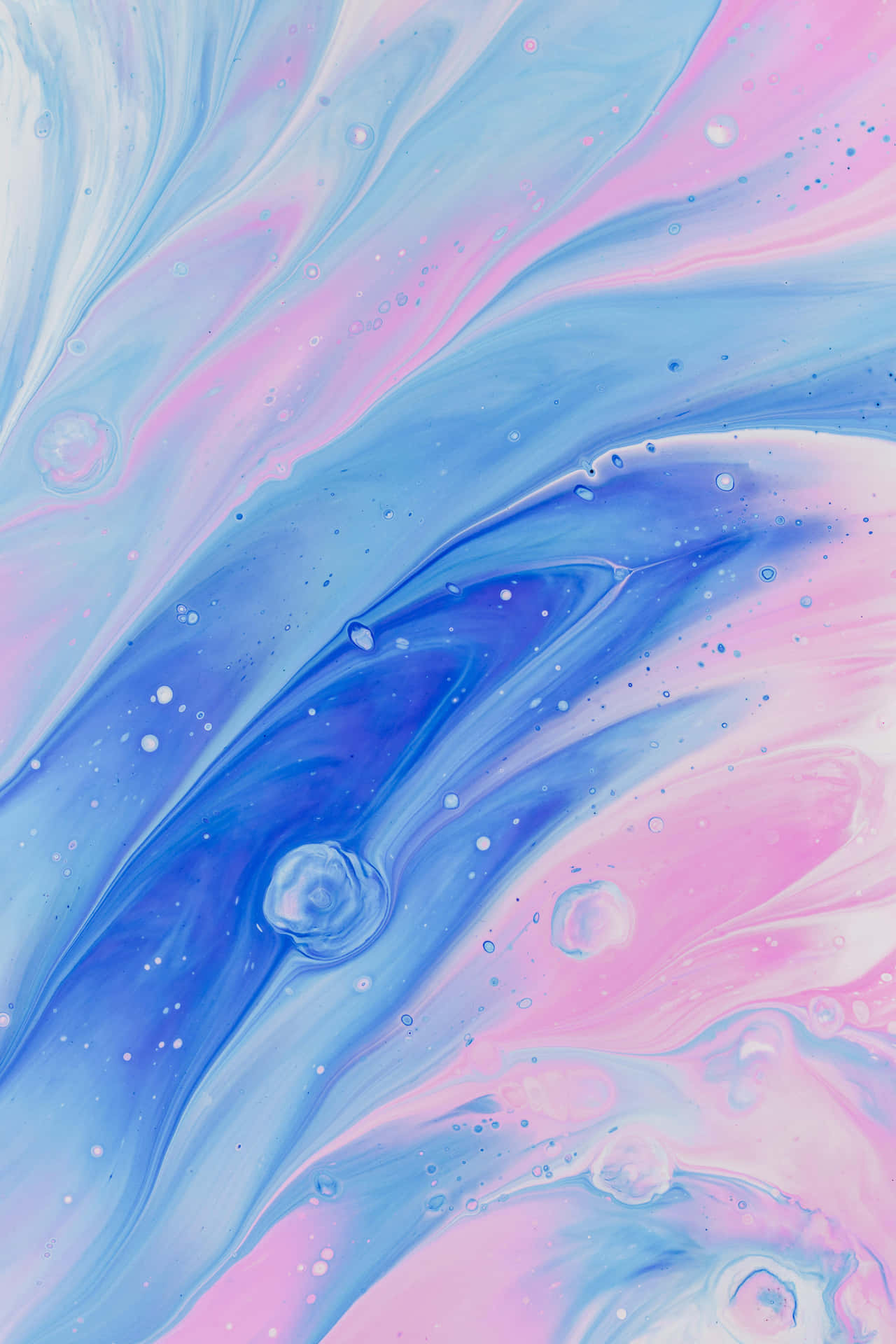 A Blue And Pink Swirling Liquid