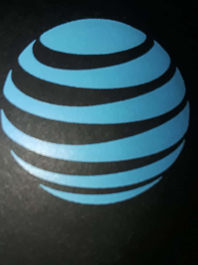 A Blue At&t Logo Is Shown On A Black Background Background