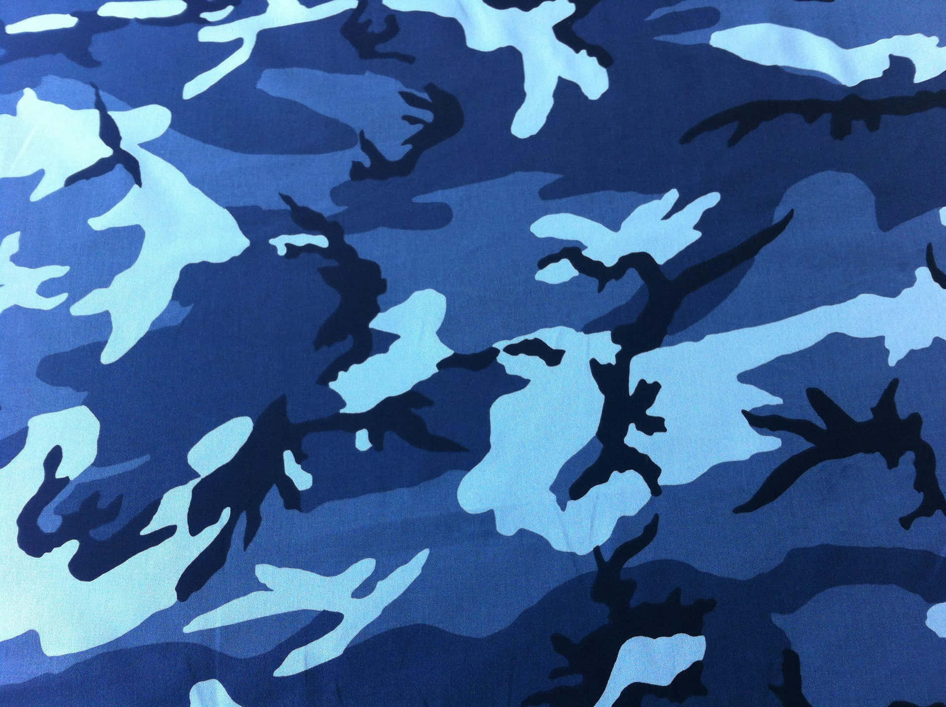 A Blue Camouflage Fabric With Black And Blue Designs Background