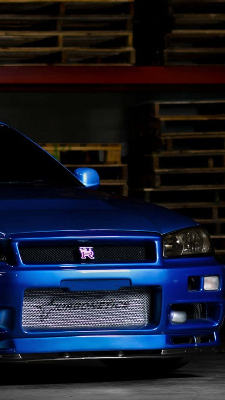 A Blue Car Parked In A Garage Background
