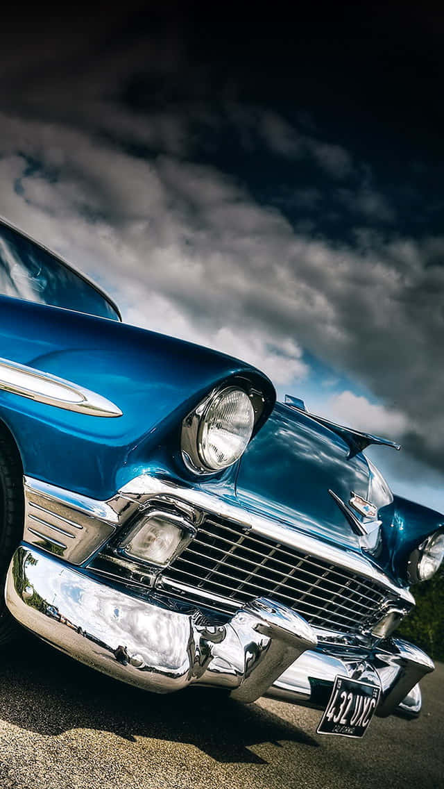 A Blue Classic Car Parked On A Street Background